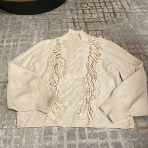Turtle neck sweater with fringe detail